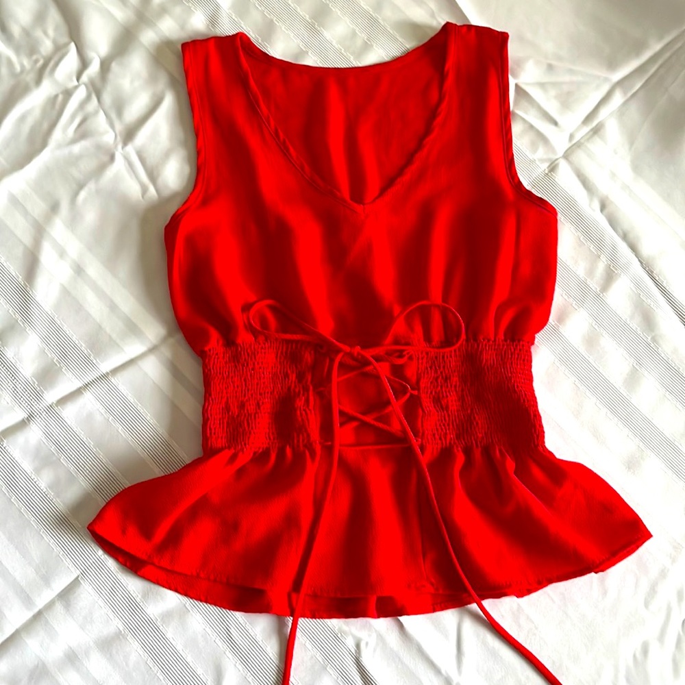 Sleeveless red tie-up blouse